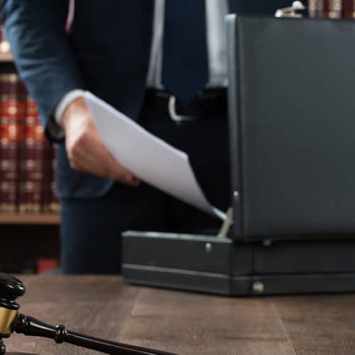 attorney putting estate planning documents in briefcase