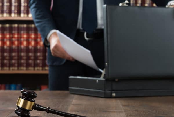 attorney putting estate planning documents in briefcase
