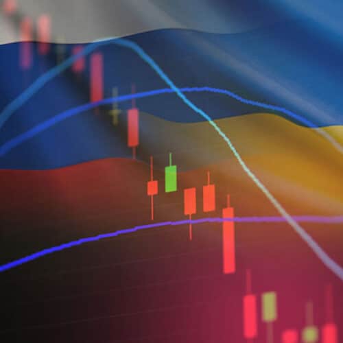 russian and ukraine flags over stock ticker