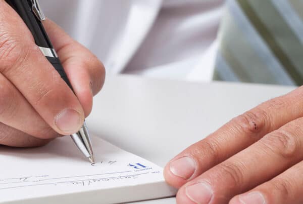 doctor writing prescription for financial wellness - financial guide for physicians and doctors