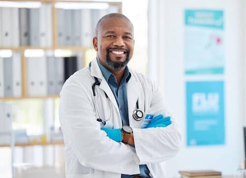 confident, young doctor in a white coat reviewing life insurance plans