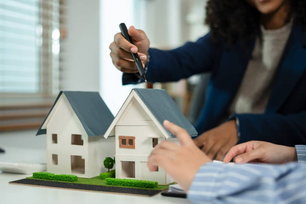 Men's hands and mini models of houses