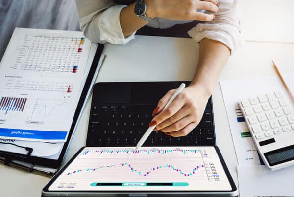 image showing someone examining market charts and analytics