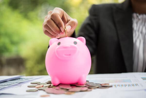 piggy bank on top of an investment portfolio chart