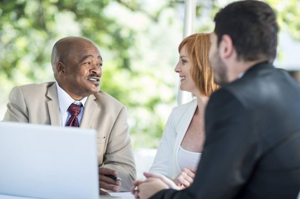 physician couple interviewing financial advisor