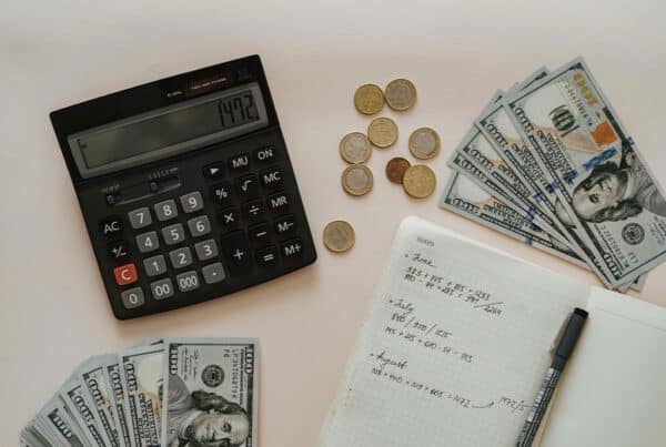 image showing calculator, money and some calculations